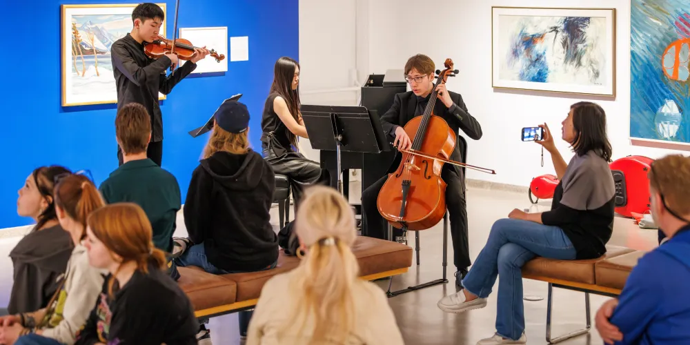 A trio of musicians performs inside an art gallery at Vibe Fest.