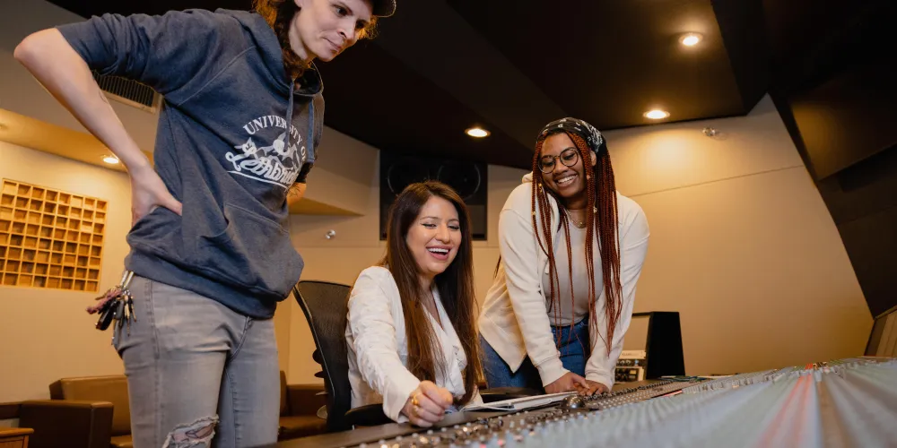 A group of students at a sound board