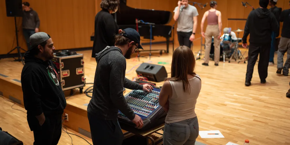 A group of students setting up a recital hall