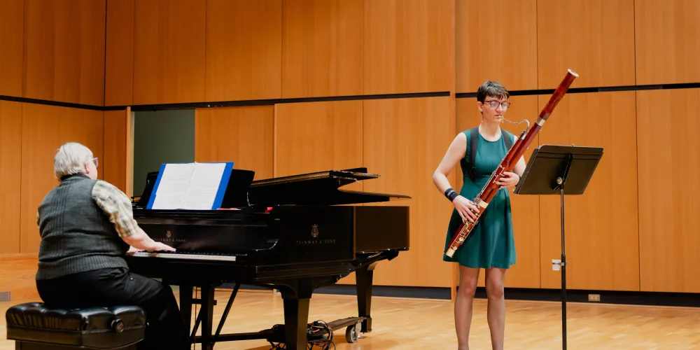 A student performing with an oboe and piano