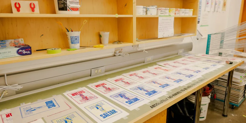 A row of images in a printmaking studio