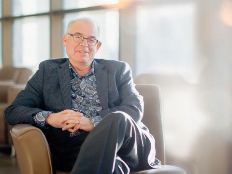Bruce McKillop sitting in chair