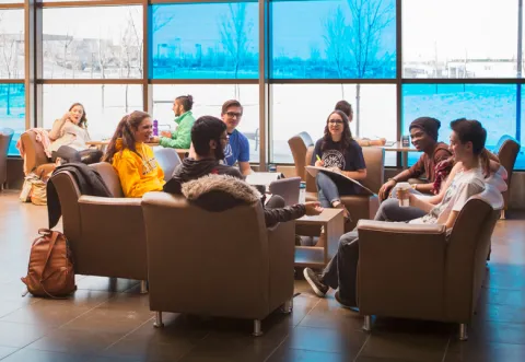 Students in the atrium of the Dhillon School of Business