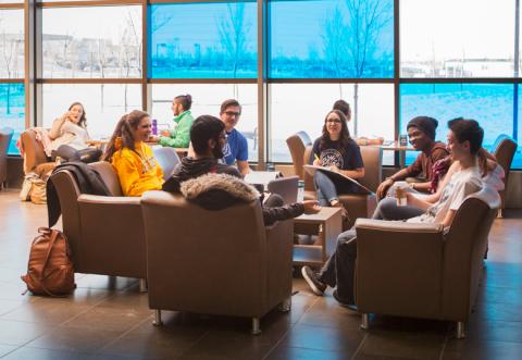 Students in the atrium of the Dhillon School of Business