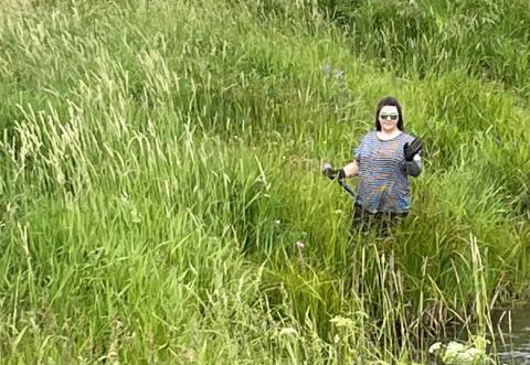 ULethbridge student Rebeca Spencer working in the field with environmentalists and stewards of land in southern Alberta