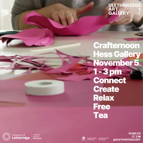 A person working on a pink paper craft.