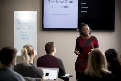 Student presenting in front of their classmates