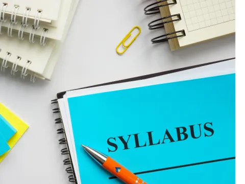 notebook with syllabus written on it