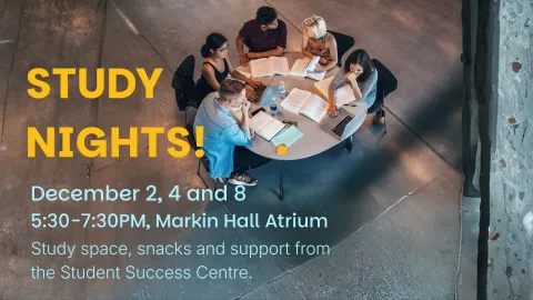 Image of students sitting around a table studying together.