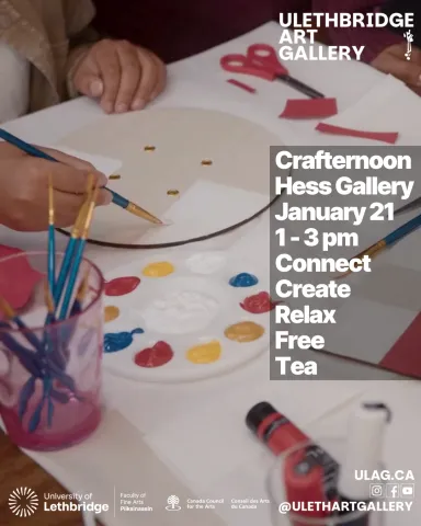 close up of a person painting on a circular canvas board.