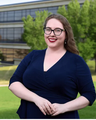Meghan Brennan (BA ‘15) stands in front of ULethbridge