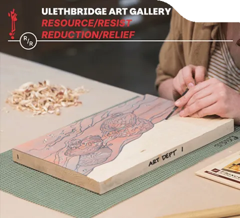 A person carving into wood for woodblock printing