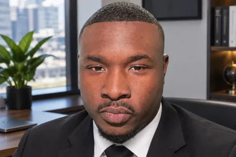 man in a suit in front of a city skyline