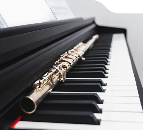 a photo of a flute on top of piano keys