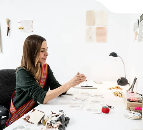 photo of Lara Felsing seated at her desk working on a project.