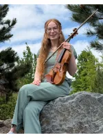 Young woman with long hair, holding a violin.