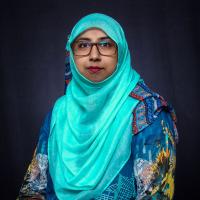 Photo portrait of a woman wearing glasses, red lipstick and a turquoise hijab