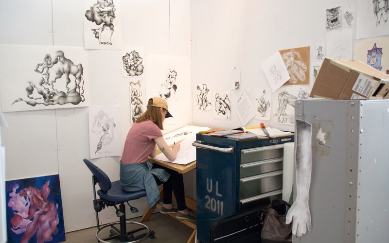 Art student sitting at individual desk