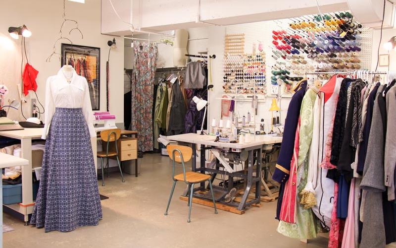 sewing station and rack of costumes