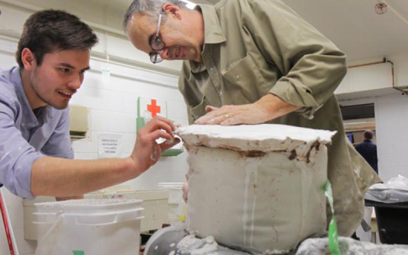 glen mackinnon and student working on sculpture