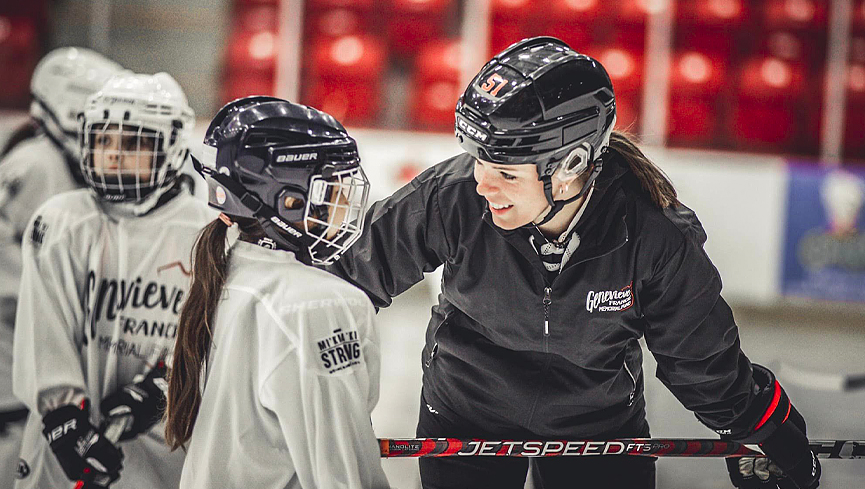 Victoria Bach, a member of the Mohawks of the Bay of Quinte First Nation and former member of the Ottawa Charge and the Canadian women's national hockey team, works with a young Mi'kmaw athlete.