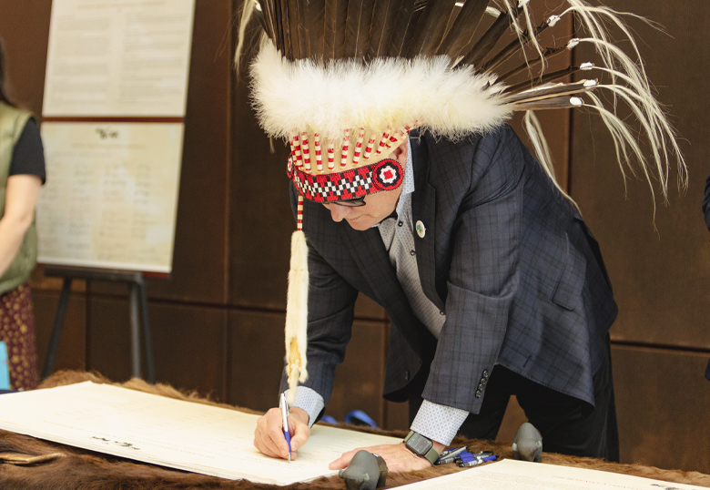 ULethbridge President & Vice-Chancellor Dr. Mike Mahon signs the historic Buffalo Treaty.