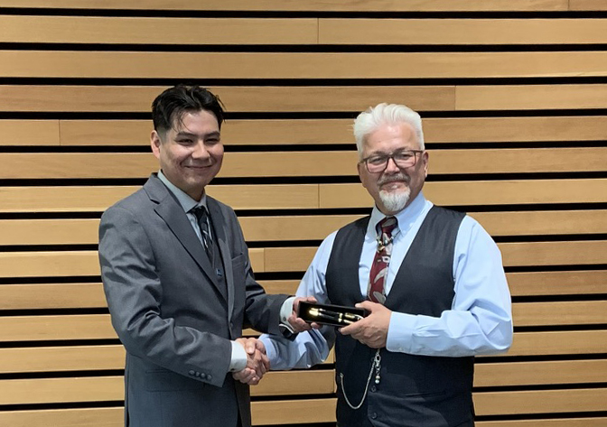 Braydon Day Chief, at left, receives the Poomaksin Pens Award from Don McIntyre.