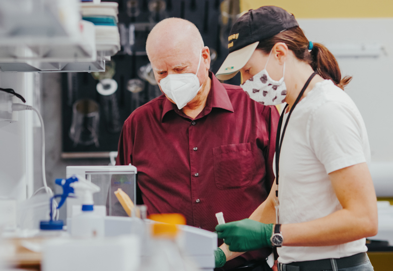 Dr. Robert Sutherland in lab with student