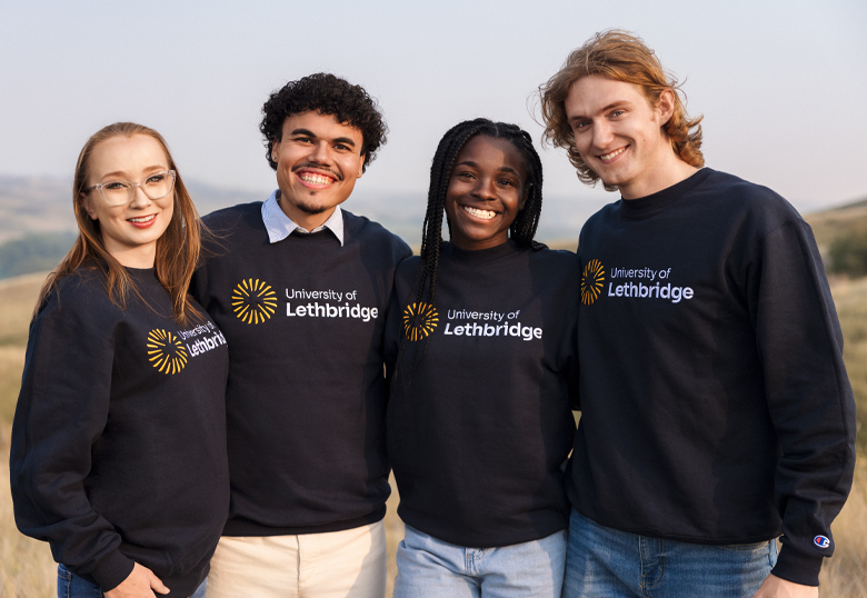 ULethbridge students with new crewneck shirts displaying the ULethbridge brand.