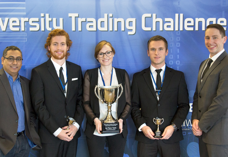 Dr. Vishaal Baulkaran, far left, coached U of L students, from left to right, Conner Williams, Brooke Winarski, Jason Murray and Cameron Pituley, to a first-place finish in the recent University Trading Challenge.