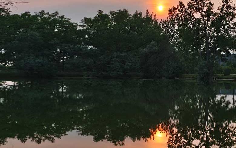 The setting sun reflected in Aperture Lake