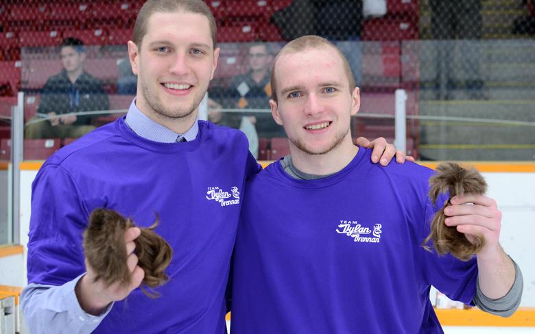 Pronghrons defenceman Aaron Enns, left, and centre Artsiom Kalashnikov display the hair they had shaved off in support of the fight against cancer. The duo were able to donate their hair to help make wigs for patients undergoing cancer treatments.