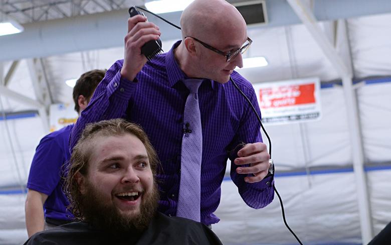 Horns fourth-year goaltender Dylan Tait, who is battling testicular cancer, takes the razor to fourth-year centre Mark Hall of Kamloops, B.C.
