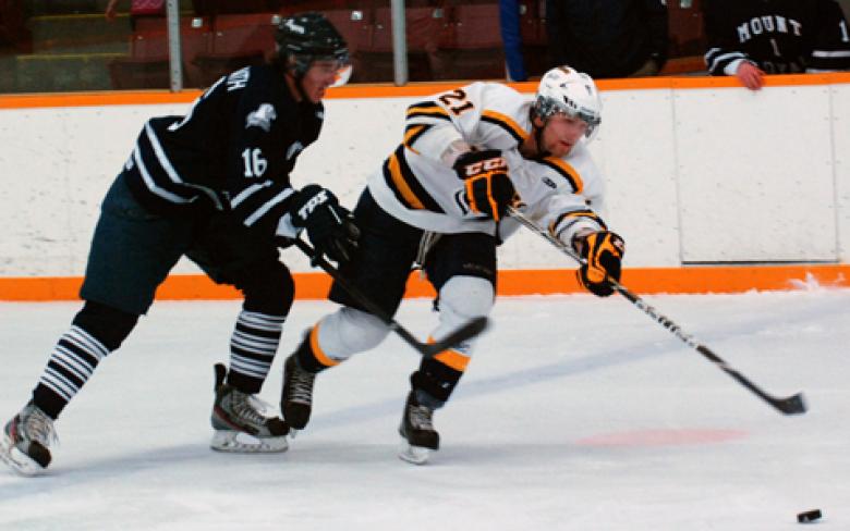 Horns forward Cass Mappin fights off a check during Canada West play against the Mount Royal University Cougars.